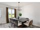 Elegant dining room featuring a stylish chandelier, large windows, and ample seating for gatherings at 1919 Plott Balsam Dr, Wendell, NC 27591
