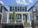 Charming two-story home featuring a welcoming front porch and a bright yellow front door at 1919 Plott Balsam Dr, Wendell, NC 27591