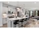 Modern eat-in kitchen featuring white cabinets, stainless steel appliances, and pendant lighting at 1919 Plott Balsam Dr, Wendell, NC 27591