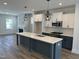 Spacious kitchen with a large island, modern pendant lights, and stainless steel appliances at 1919 Plott Balsam Dr, Wendell, NC 27591