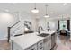 Open kitchen with a large island, stainless steel sink, and an adjacent dining area at 1919 Plott Balsam Dr, Wendell, NC 27591