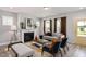 Bright living room featuring a fireplace, modern decor, and a seamless flow to the outdoors at 1919 Plott Balsam Dr, Wendell, NC 27591