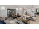 Open-concept living room featuring modern decor, hardwood floors, and an adjacent eat-in kitchen at 1919 Plott Balsam Dr, Wendell, NC 27591