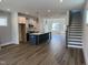 Open concept home featuring a kitchen island, dining area, fireplace, and hardwood floors at 1919 Plott Balsam Dr, Wendell, NC 27591