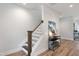 Well-lit staircase with decorative wallpaper, stylish decor, and hardwood flooring at 1919 Plott Balsam Dr, Wendell, NC 27591