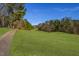 Backyard view looking down a long green fairway with trees on either side at 271 Sacred Fire Rd, Louisburg, NC 27549