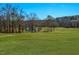 Expansive green backyard with view of a small lake in the background at 271 Sacred Fire Rd, Louisburg, NC 27549