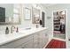 Well-lit bathroom with a double sink vanity, modern fixtures, and access to a walk-in closet at 271 Sacred Fire Rd, Louisburg, NC 27549