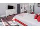 Bright bedroom featuring a decorative rug, a gray accent wall, and an open doorway to the bathroom at 271 Sacred Fire Rd, Louisburg, NC 27549