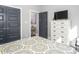 Comfortable bedroom featuring warm bedding, television, and access to a bathroom at 271 Sacred Fire Rd, Louisburg, NC 27549