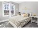 Inviting bedroom with bright window, neutral color scheme, and stylish bedding at 271 Sacred Fire Rd, Louisburg, NC 27549