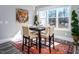 Cozy dining area with a square table, seating for four, and a large window at 271 Sacred Fire Rd, Louisburg, NC 27549