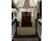 A home entrance with a covered front porch, brick steps, and flower pots at 271 Sacred Fire Rd, Louisburg, NC 27549