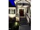 A home exterior featuring the front porch, illuminated steps, and landscape at 271 Sacred Fire Rd, Louisburg, NC 27549