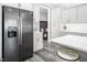 Bright kitchen with stainless steel appliances, gray cabinets, and convenient breakfast bar seating at 271 Sacred Fire Rd, Louisburg, NC 27549