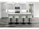 Stylish kitchen featuring an island with seating, gray cabinetry, and modern lighting at 271 Sacred Fire Rd, Louisburg, NC 27549