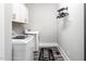 Efficient laundry room with modern washer and dryer, cabinetry and ample space at 271 Sacred Fire Rd, Louisburg, NC 27549