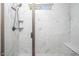 Modern shower with marble-patterned tile, glass door, and built-in shelving at 271 Sacred Fire Rd, Louisburg, NC 27549