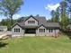 Rear view of the home highlighting the backyard space, large windows, and modern design at 2829 Theresa Eileen Way, Raleigh, NC 27603