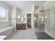 Primary bathroom featuring a soaking tub, vanity, and a glass-enclosed shower at 2829 Theresa Eileen Way, Raleigh, NC 27603