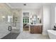 A spa-like bathroom features a glass shower with seating, a double sink vanity, and soaking tub at 2829 Theresa Eileen Way, Raleigh, NC 27603
