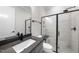 Modern bathroom with a black framed glass shower, and a vanity with a grey countertop at 2829 Theresa Eileen Way, Raleigh, NC 27603