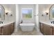 Bright bathroom with soaking tub, dual vanities, and stylish fixtures at 2829 Theresa Eileen Way, Raleigh, NC 27603