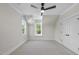Cozy bedroom featuring plush carpeting, a ceiling fan, and bright windows at 2829 Theresa Eileen Way, Raleigh, NC 27603