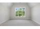 Bright bedroom with a large window overlooking lush greenery and plush carpeting at 2829 Theresa Eileen Way, Raleigh, NC 27603