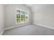 Bright bedroom with a large window overlooking neighborhood and plush carpeting at 2829 Theresa Eileen Way, Raleigh, NC 27603