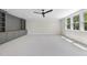 Large bonus room with built-in cabinets, plush carpet, and natural light from large windows at 2829 Theresa Eileen Way, Raleigh, NC 27603