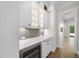 Butler pantry with quartz counters, wine cooler, mosaic backsplash, and storage at 2829 Theresa Eileen Way, Raleigh, NC 27603