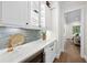 Butler's pantry features quartz counters, wine fridge, shaker cabinets and gray backsplash at 2829 Theresa Eileen Way, Raleigh, NC 27603