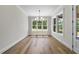 Bright dining room with hardwood floors, large windows, and modern chandelier at 2829 Theresa Eileen Way, Raleigh, NC 27603