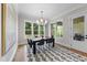 Dining room with a modern chandelier, natural light, and backyard views from windows at 2829 Theresa Eileen Way, Raleigh, NC 27603