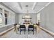Beautiful dining room features modern chandelier, gray walls, and a large window with natural light at 2829 Theresa Eileen Way, Raleigh, NC 27603