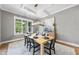 Dining room with gray walls, hardwood floors, coffered ceiling, and a large window with backyard view at 2829 Theresa Eileen Way, Raleigh, NC 27603
