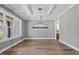 Bright dining room with modern light fixture, coffered ceilings, and hardwood floors at 2829 Theresa Eileen Way, Raleigh, NC 27603