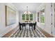 Dining room features a modern chandelier, large windows, and neutral-toned walls and floors at 2829 Theresa Eileen Way, Raleigh, NC 27603