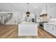 Open kitchen layout with a large center island, stainless steel appliances, and hardwood floors at 2829 Theresa Eileen Way, Raleigh, NC 27603