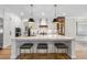 Bright and airy kitchen features quartz island with pendant lights and hardwood floors at 2829 Theresa Eileen Way, Raleigh, NC 27603