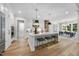 Kitchen with island, breakfast bar seating, and white cabinets open to the dining room at 2829 Theresa Eileen Way, Raleigh, NC 27603