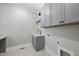 Functional laundry room with gray cabinetry and modern fixtures at 2829 Theresa Eileen Way, Raleigh, NC 27603