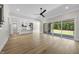 Open concept living room showcasing the modern kitchen and outdoor access at 2829 Theresa Eileen Way, Raleigh, NC 27603