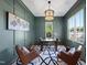 Office space features a large wooden desk, natural light, and leather chairs at 2829 Theresa Eileen Way, Raleigh, NC 27603