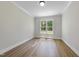 Empty office space showcasing hardwood floors and natural light from a window with green tree views at 2829 Theresa Eileen Way, Raleigh, NC 27603