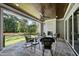 Covered outdoor patio with stone flooring, fireplace, seating area and scenic views at 2829 Theresa Eileen Way, Raleigh, NC 27603