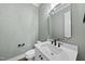 This powder room features a modern vanity with black hardware and a decorative mirror at 2829 Theresa Eileen Way, Raleigh, NC 27603