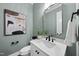 Elegant powder room with modern fixtures, stylish art, and a decorative mirror at 2829 Theresa Eileen Way, Raleigh, NC 27603