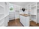 Spacious walk-in closet with wooden floors and built-in shelving at 2829 Theresa Eileen Way, Raleigh, NC 27603